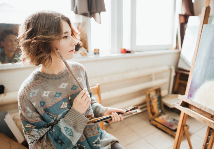 woman sitting on floor thinking about art signs you're healing from a breakup