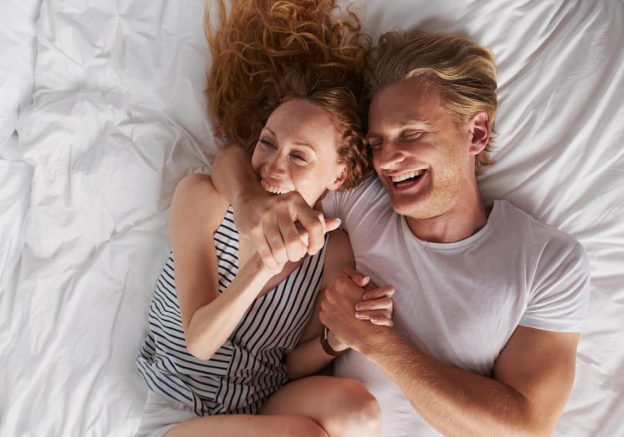 couple laughing in bed women biting man Why Do I Want to Bite My Boyfriend?