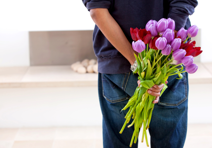 man holding flowers behind back I want a girlfriend