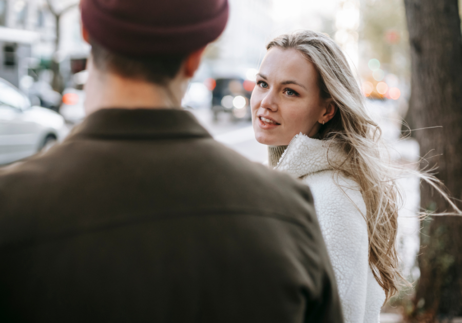 woman talking to man outdoors signs you're healing from a breakup