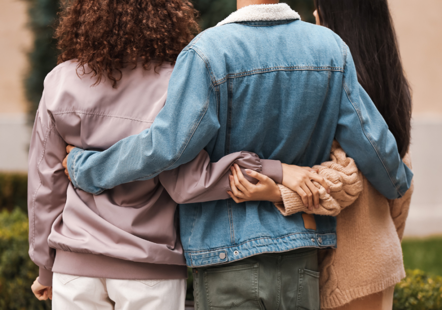 two women arms around man Symptoms of Bisexuality in Females