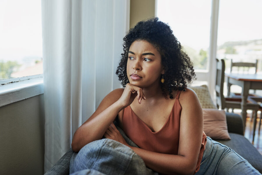 woman sitting alone looking out window when enough is enough